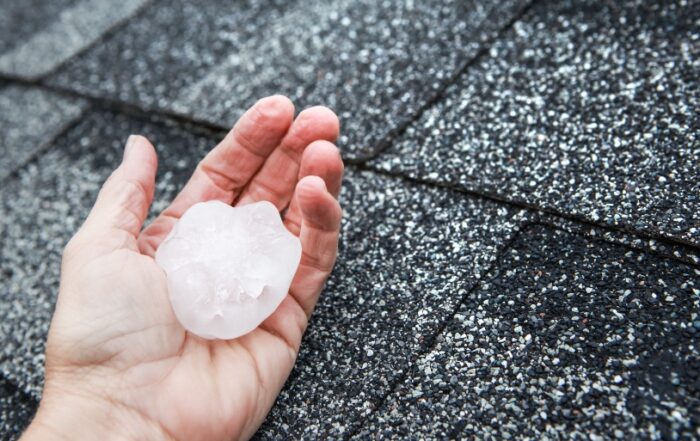 JB Roofing & Gutters in Ankeny, IA demonstrates how to prepare for hail with a photo of large hailstone damage risk on a residential roof
