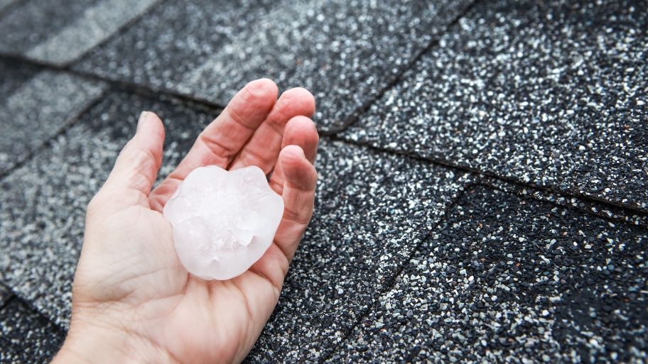photo of large hailstone damage risk on a residential roof. JB Roofing & Gutters in Ankeny, IA demonstrates how to prepare for hail with a photo of large hailstone damage risk on a residential roof