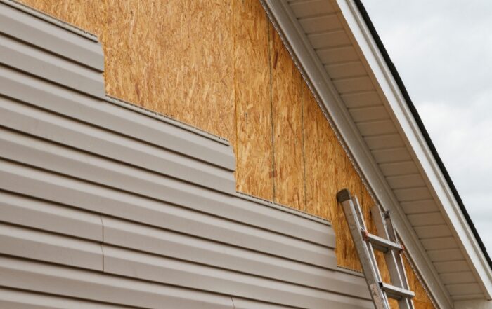 JB Roofing & Gutters installing vinyl siding on a home exterior in Iowa — example of how to pick new siding for your house