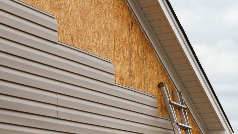 JB Roofing & Gutters installing vinyl siding on a home exterior in Iowa JB Roofing & Gutters installing vinyl siding on a home exterior in Iowa — example of how to pick new siding for your house