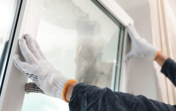 Technician installing energy-efficient window during a home window replacement by JB Roofing & Gutters in Iowa – what to look for when buying new windows